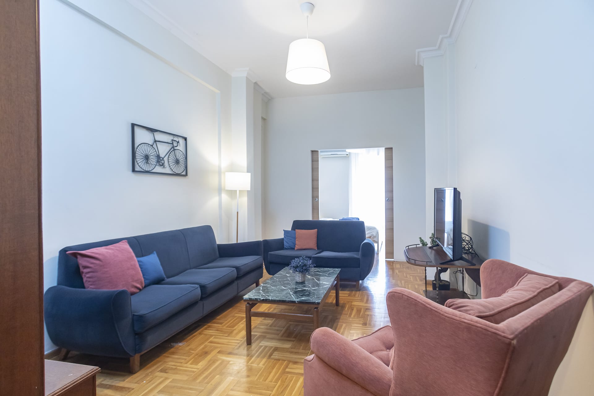 a living room with blue couches