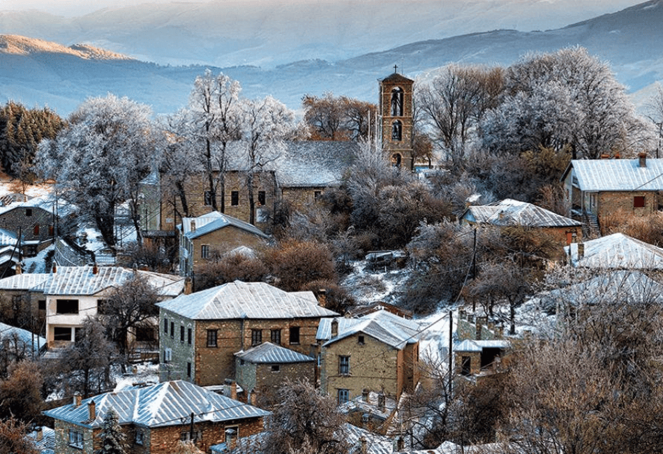 a group of houses with snow on the roofs