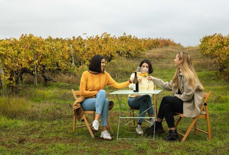 a group of people sitting around a table outside