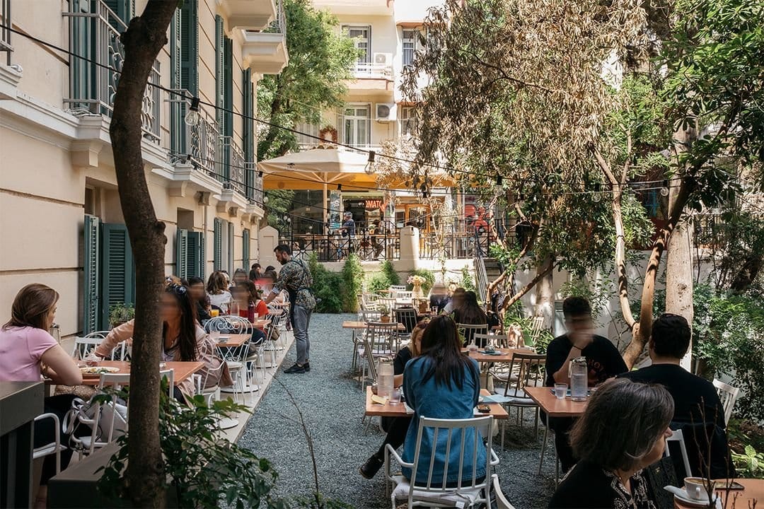people sitting at tables outside