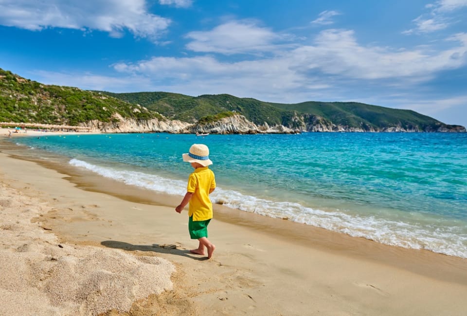 a child walking on a beach