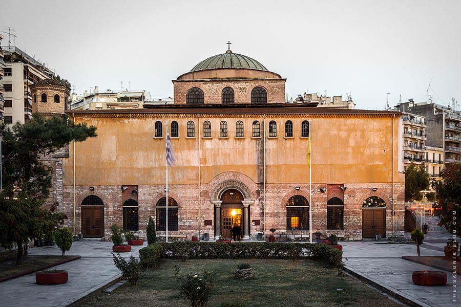 a large building with a green dome with Hagia Sophia, Thessaloniki in the background