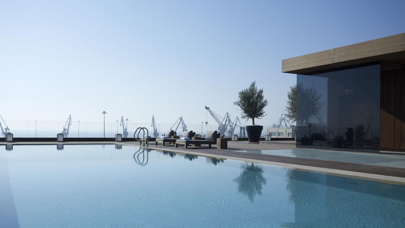 a pool with a building and trees