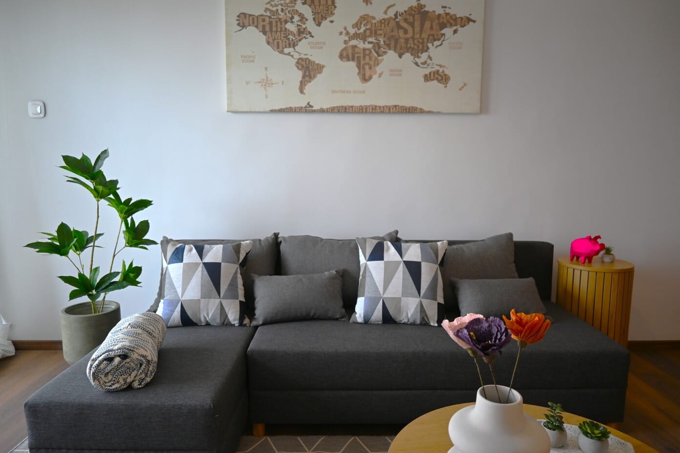 a couch with a coffee table and a map on the wall