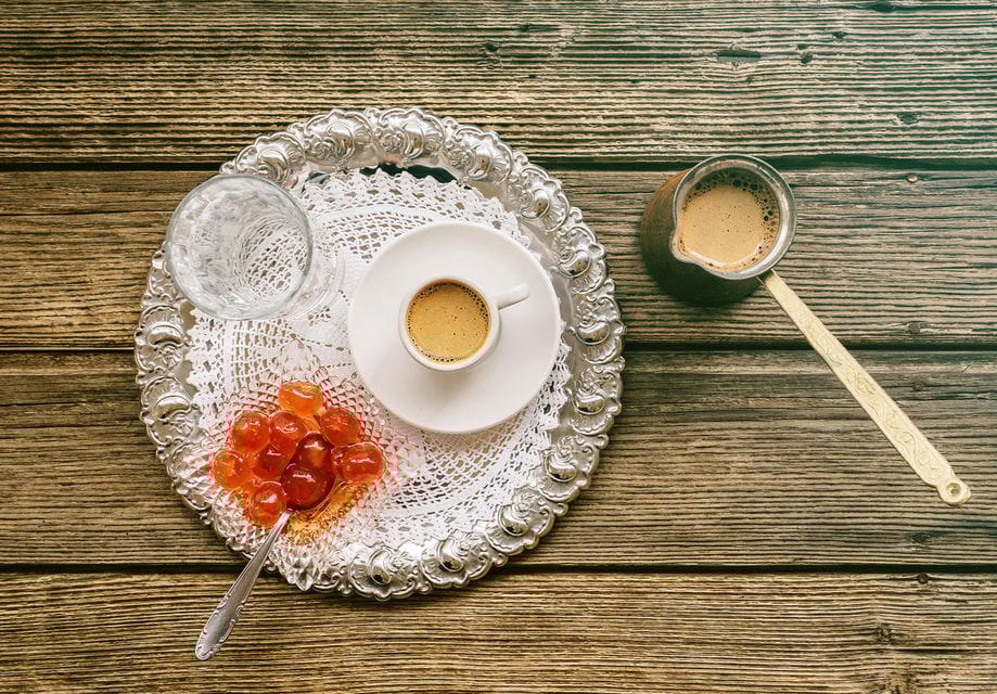 a plate of food and a cup of liquid