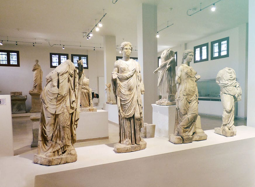 a group of statues in a museum