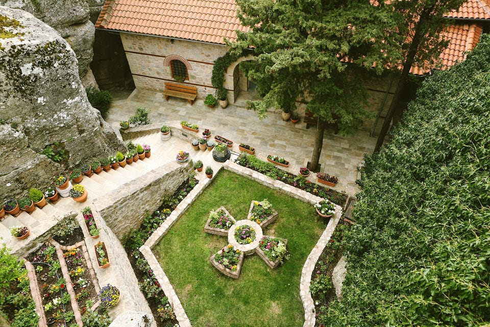 a garden with a white fence