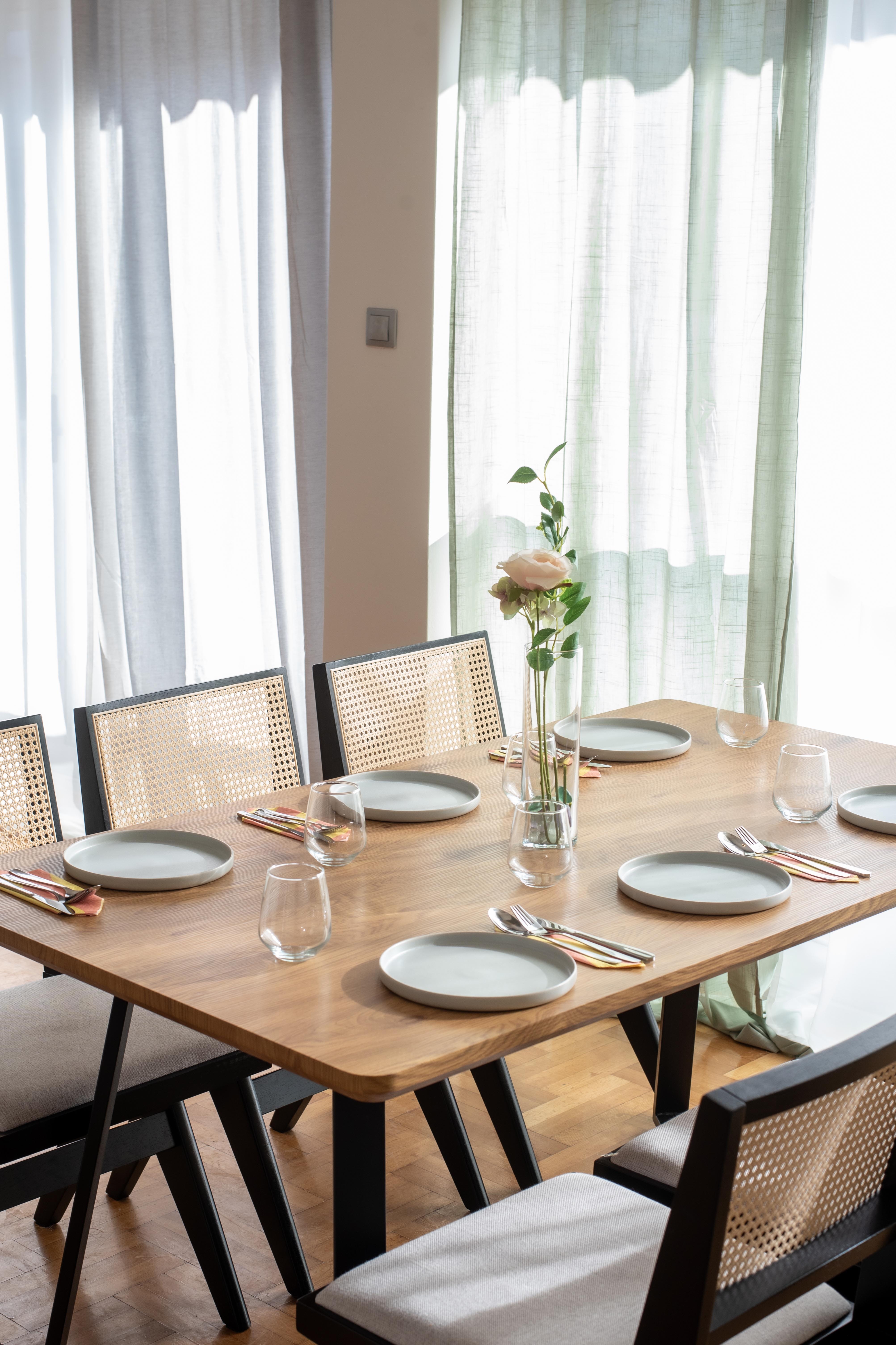a dining table with plates and glasses