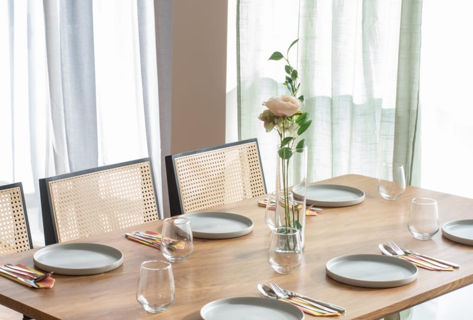 a dining table with plates and glasses