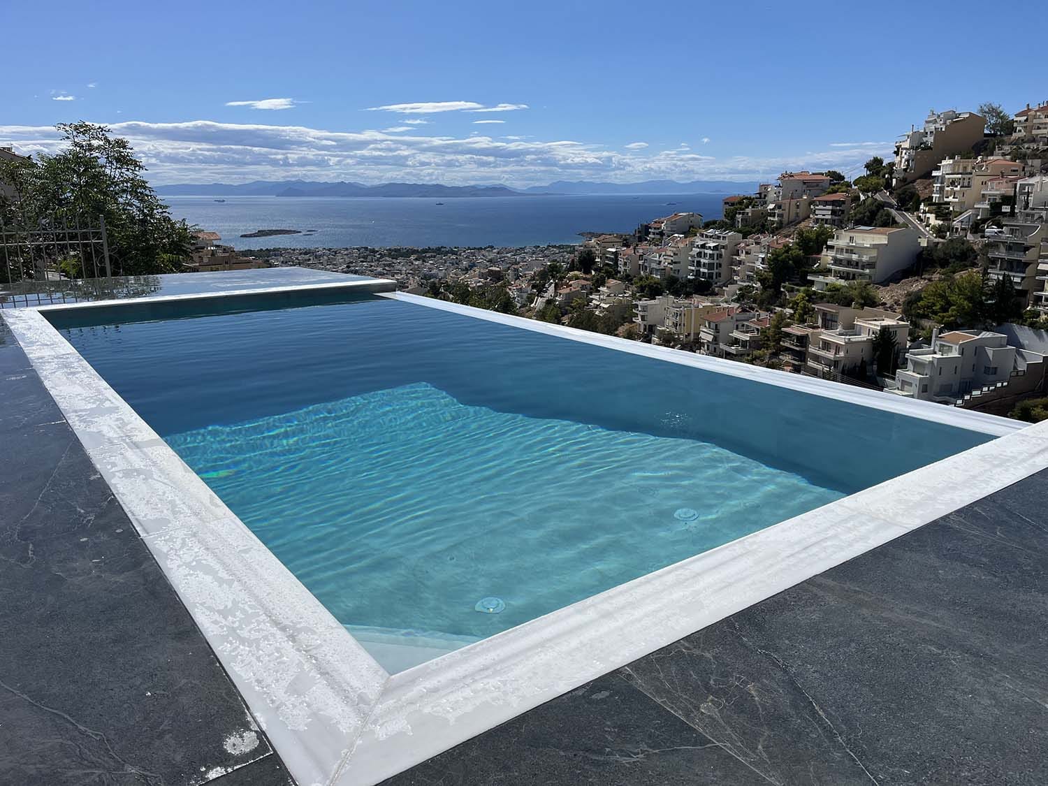 a pool with a city in the background