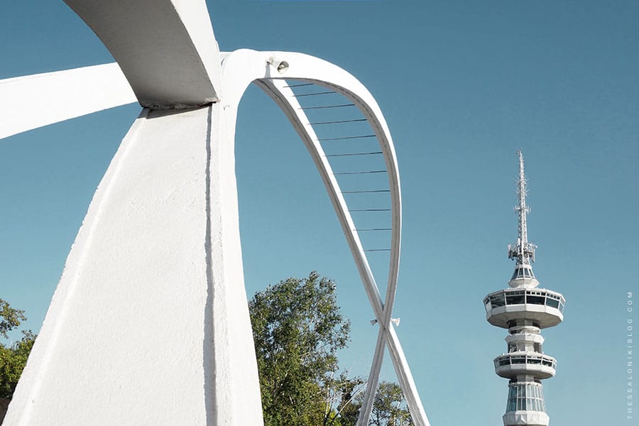 a white structure with a tower in the background