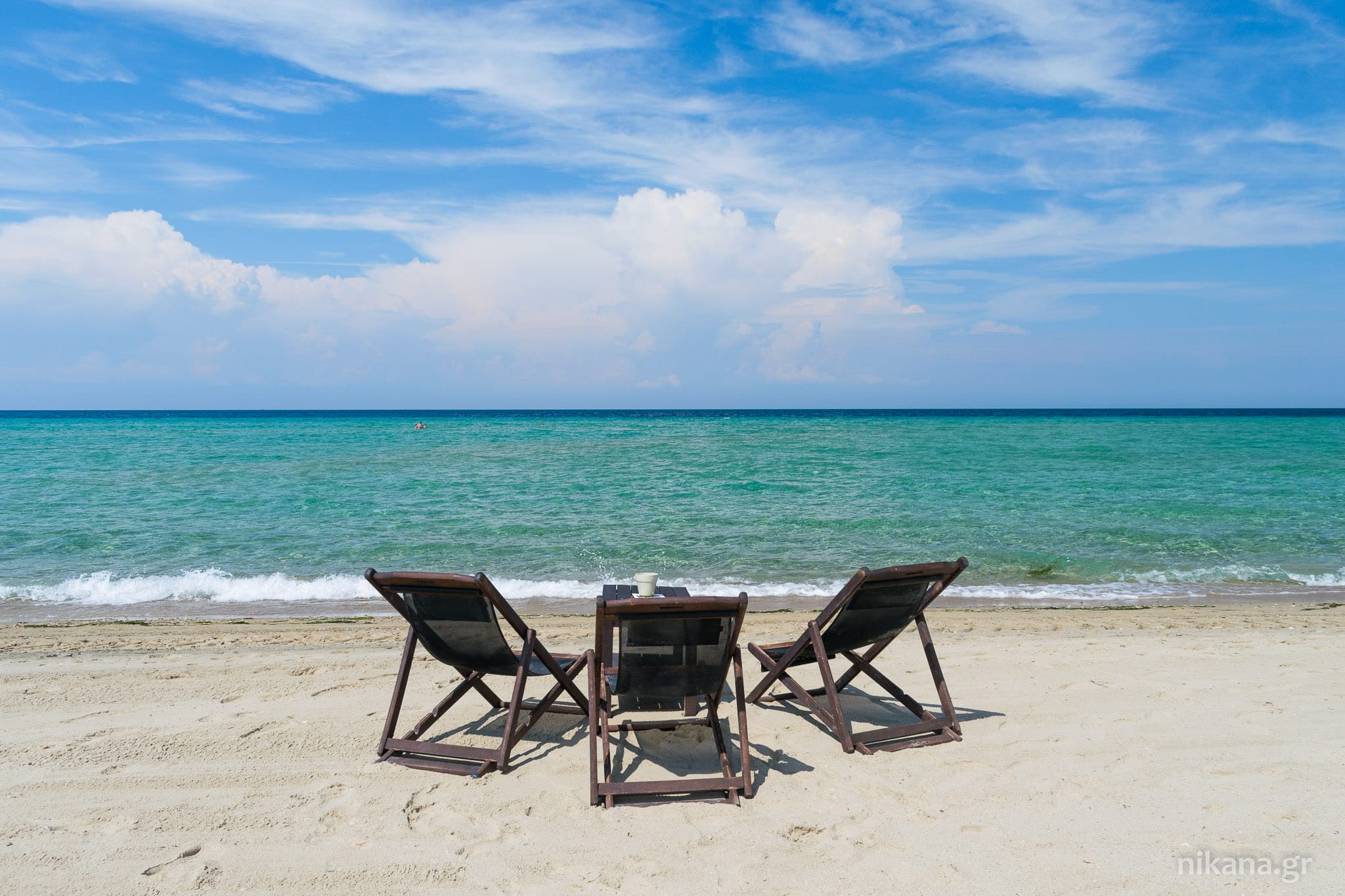 chairs and a table on a beach