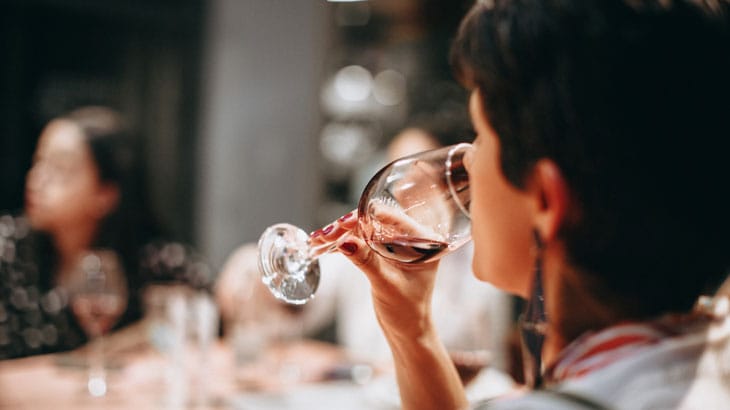a person drinking from a glass