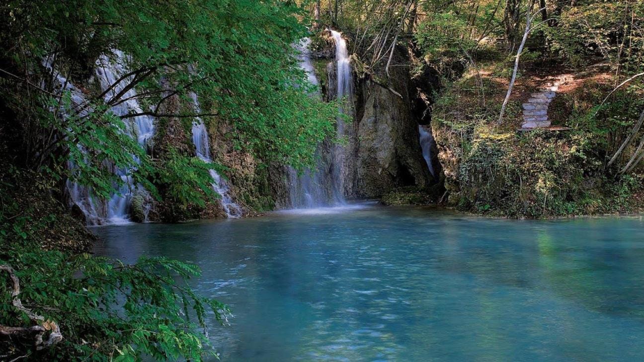 a waterfall into a pool of water