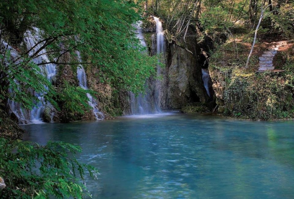 a waterfall into a pool of water
