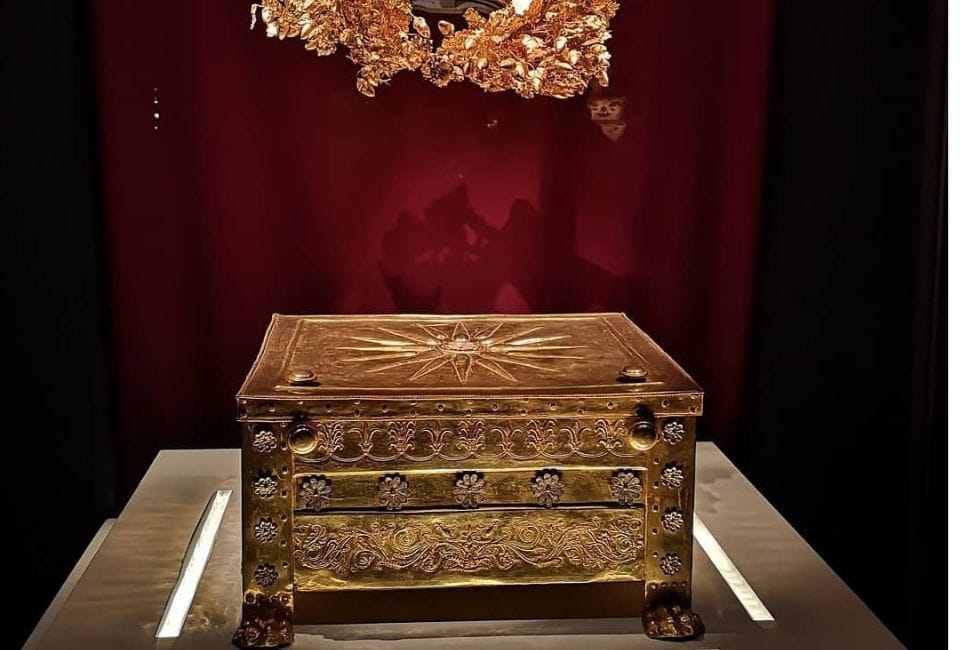 a wooden chest with a gold top