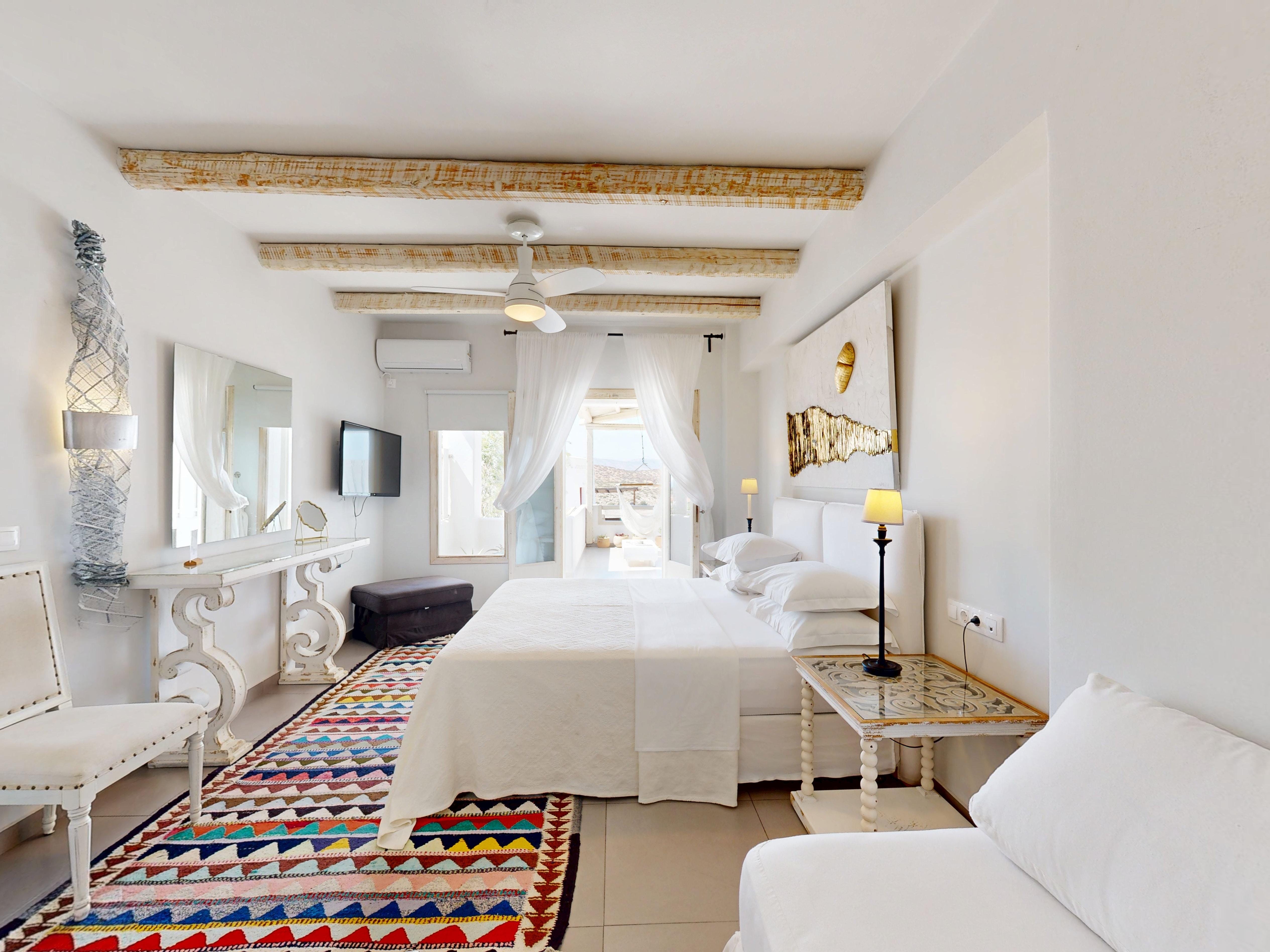 a large bedroom with a bed and a couch