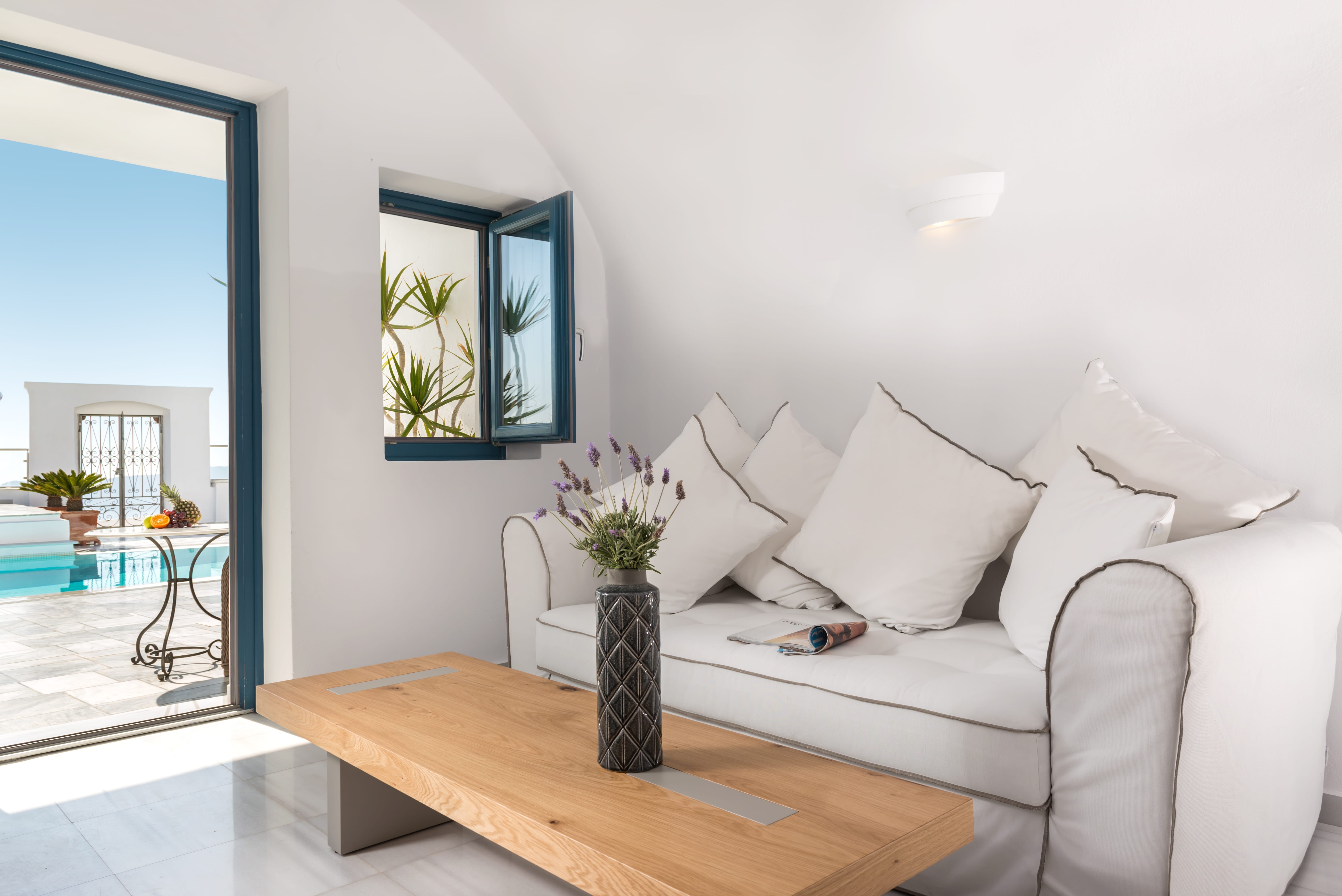 a white couch with a vase of flowers on it