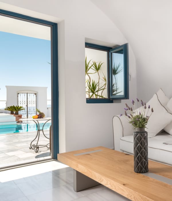 a white couch with a vase of flowers on it