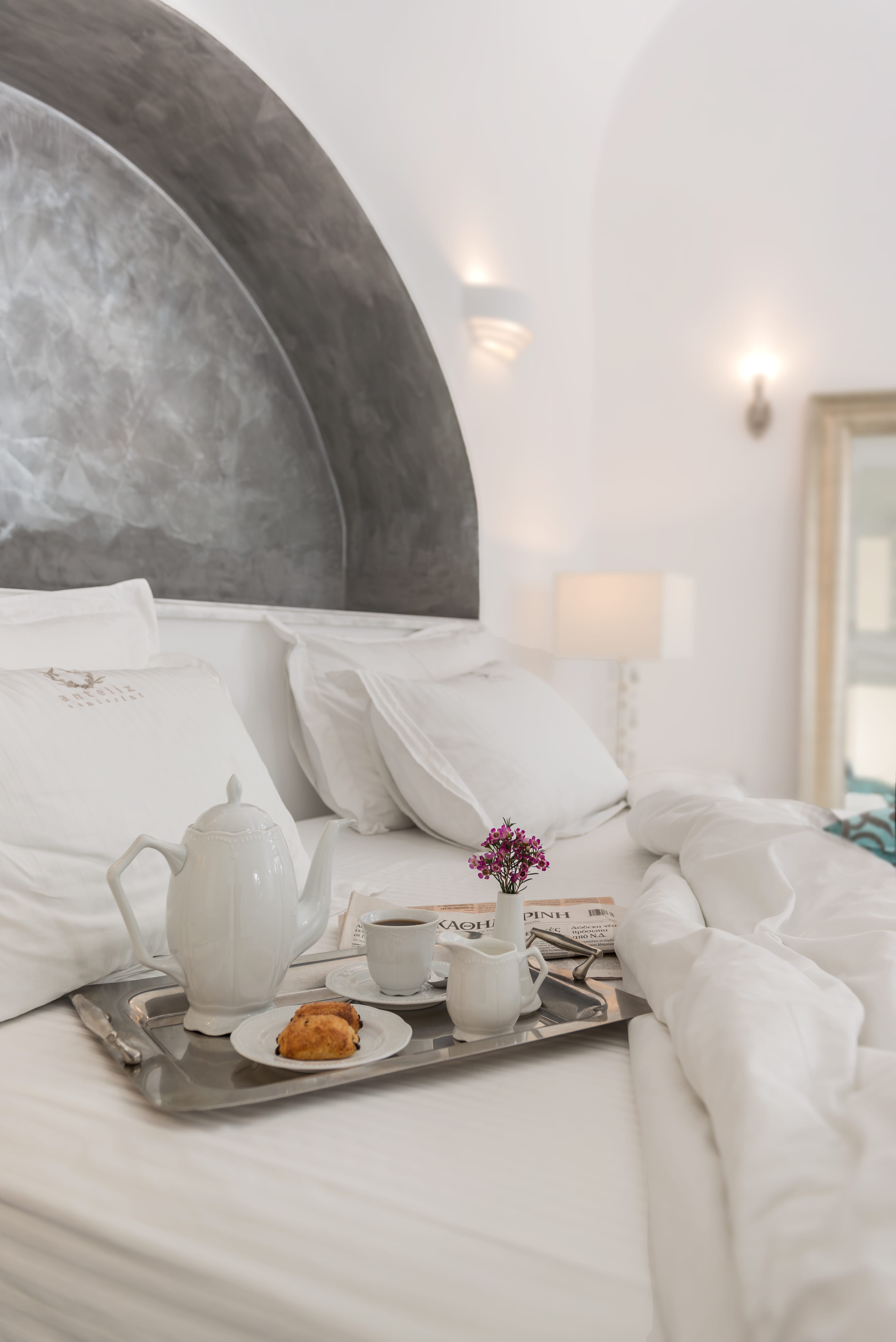 a table with a plate of food and a vase of flowers