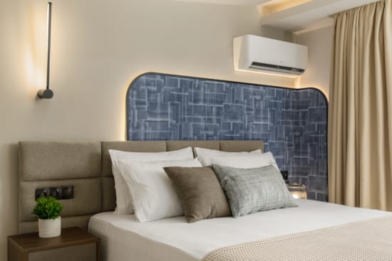 a bed with a blue wall