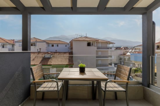 a table and chairs on a balcony