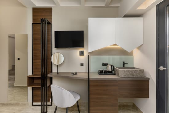 a bathroom with a tv and a chair