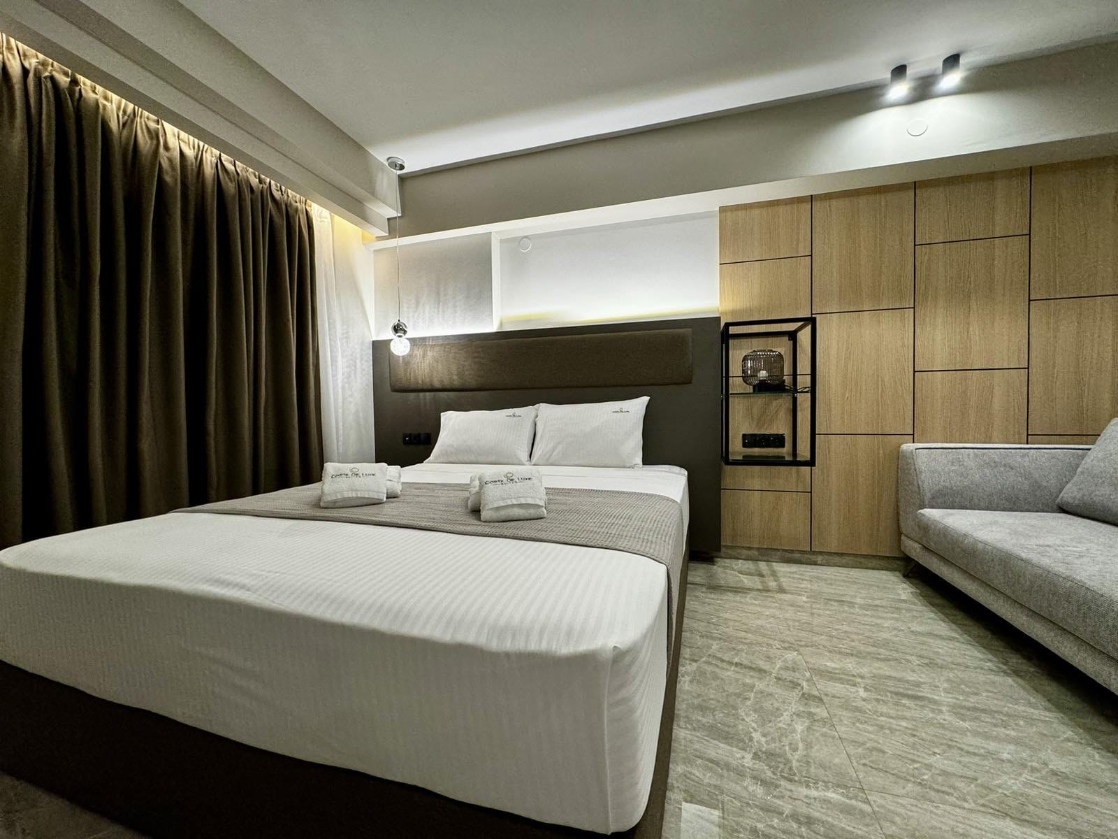 a hotel room with a bed and couches