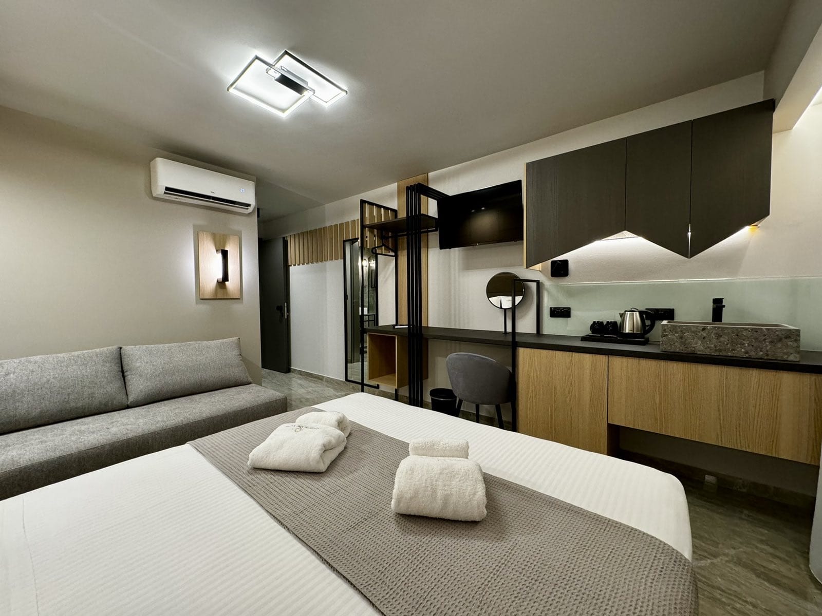 a hotel room with a bed and a couch