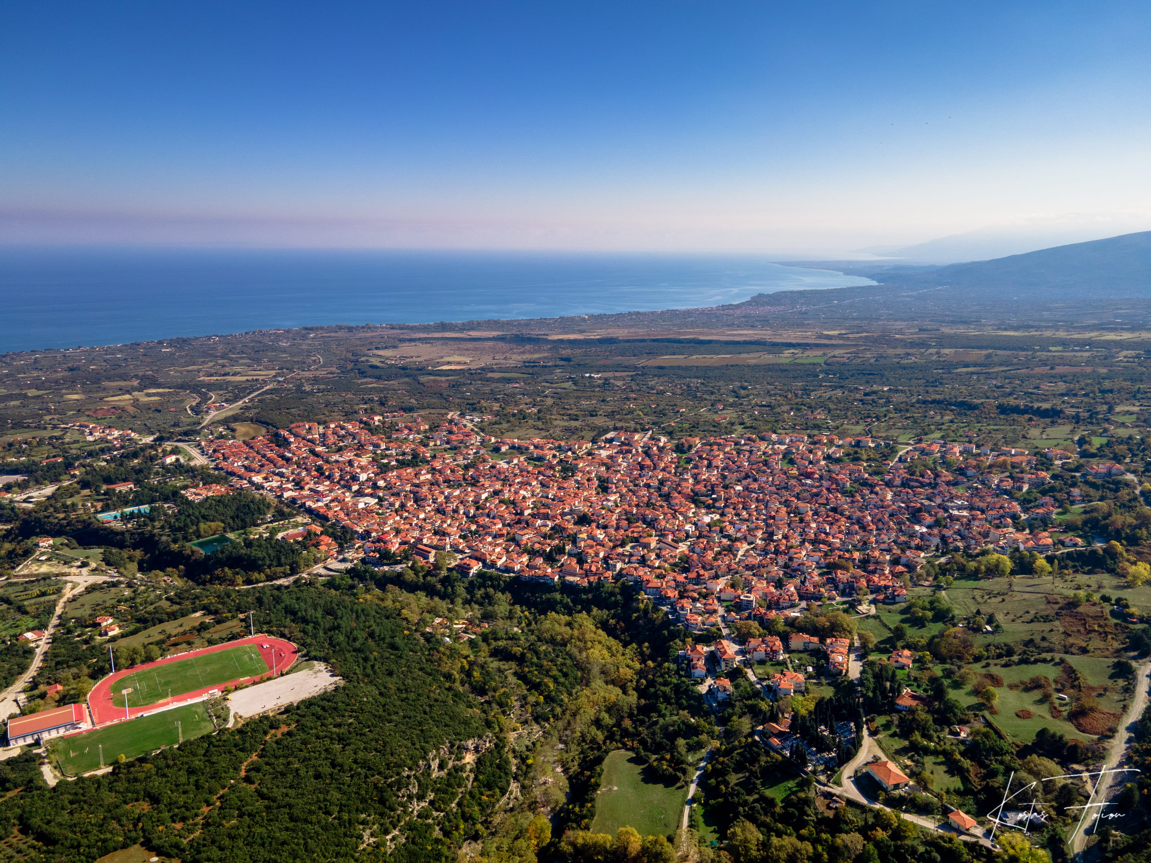 a city with a body of water in the background