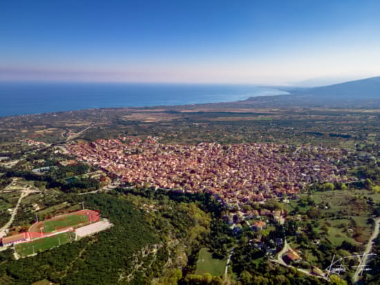 a city with a body of water in the background