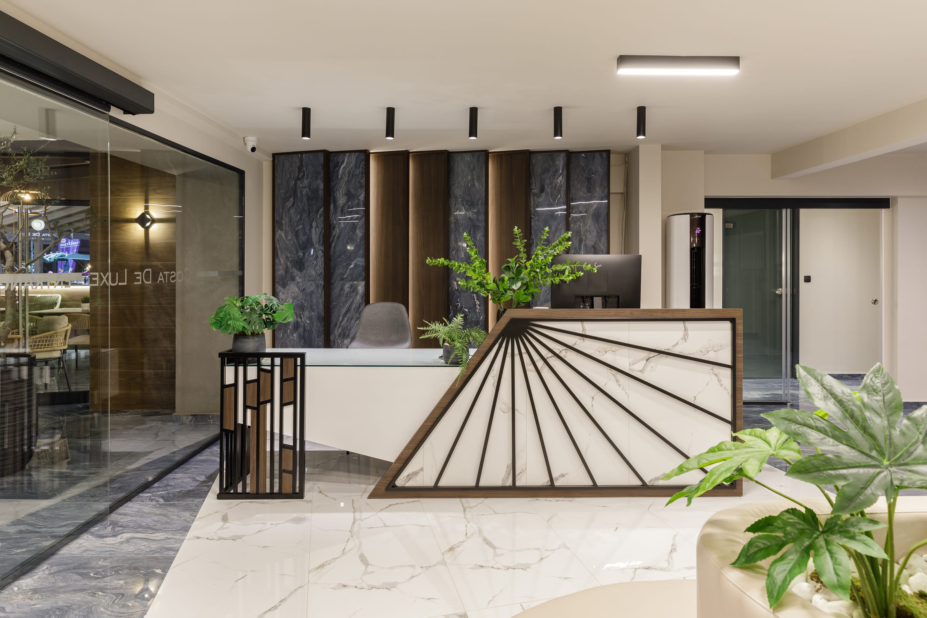 a room with a glass table and plants