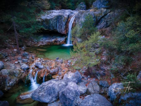 a stream of water flowing through rocks