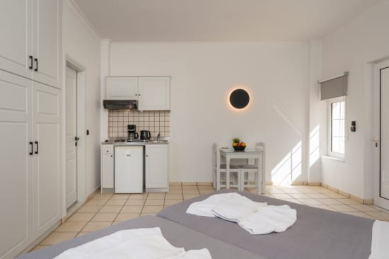 a room with white cabinets and a bed