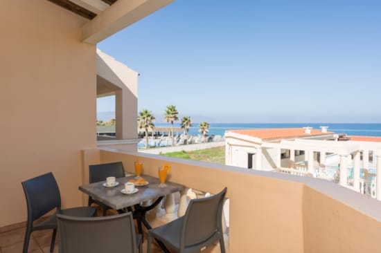 a table and chairs on a balcony