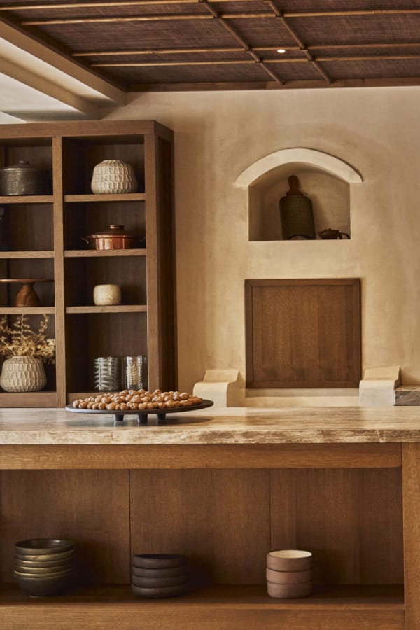 a kitchen with a shelf and a counter with a basket of food