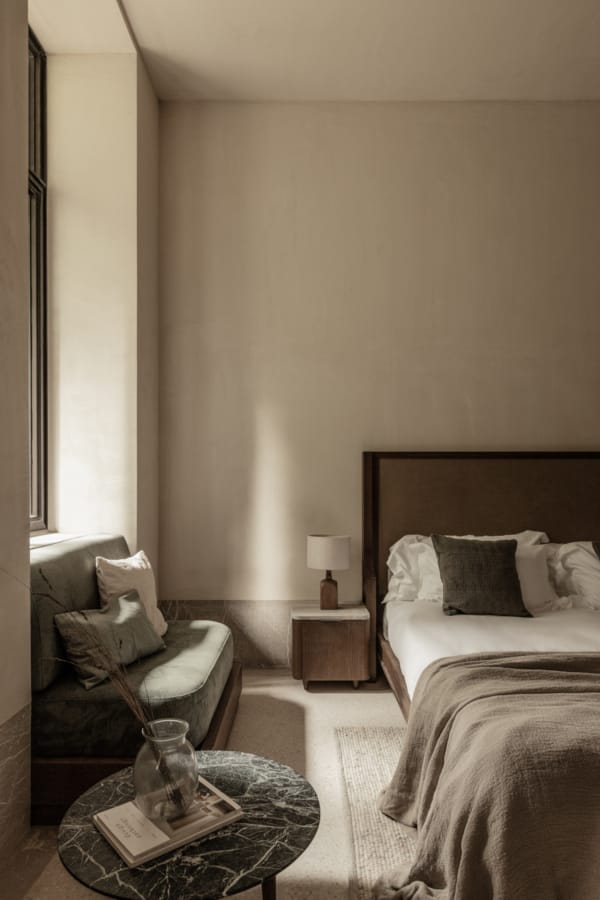 a bedroom with a bed and a coffee table