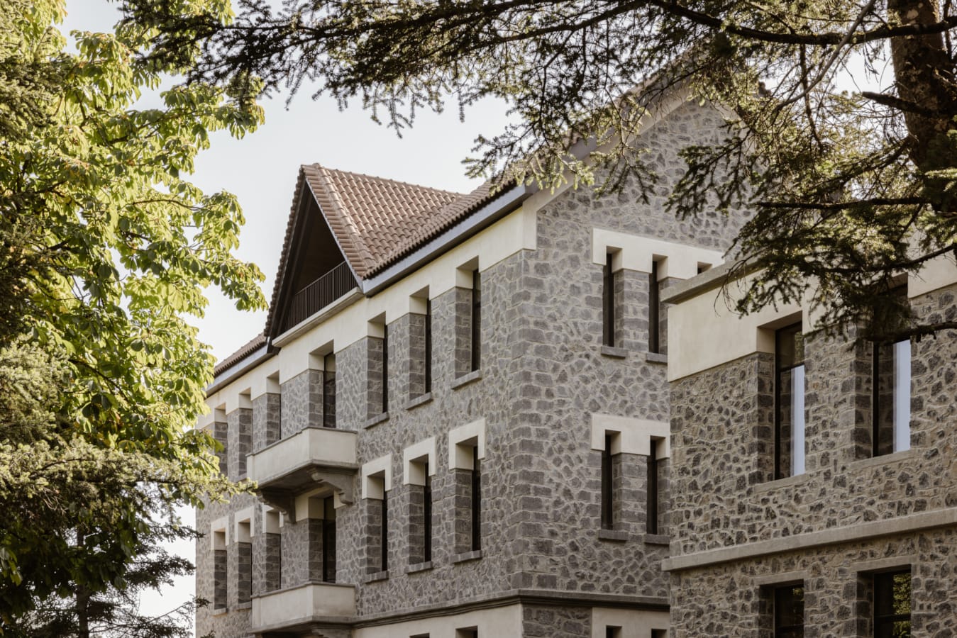 a stone building with a tree in front of it