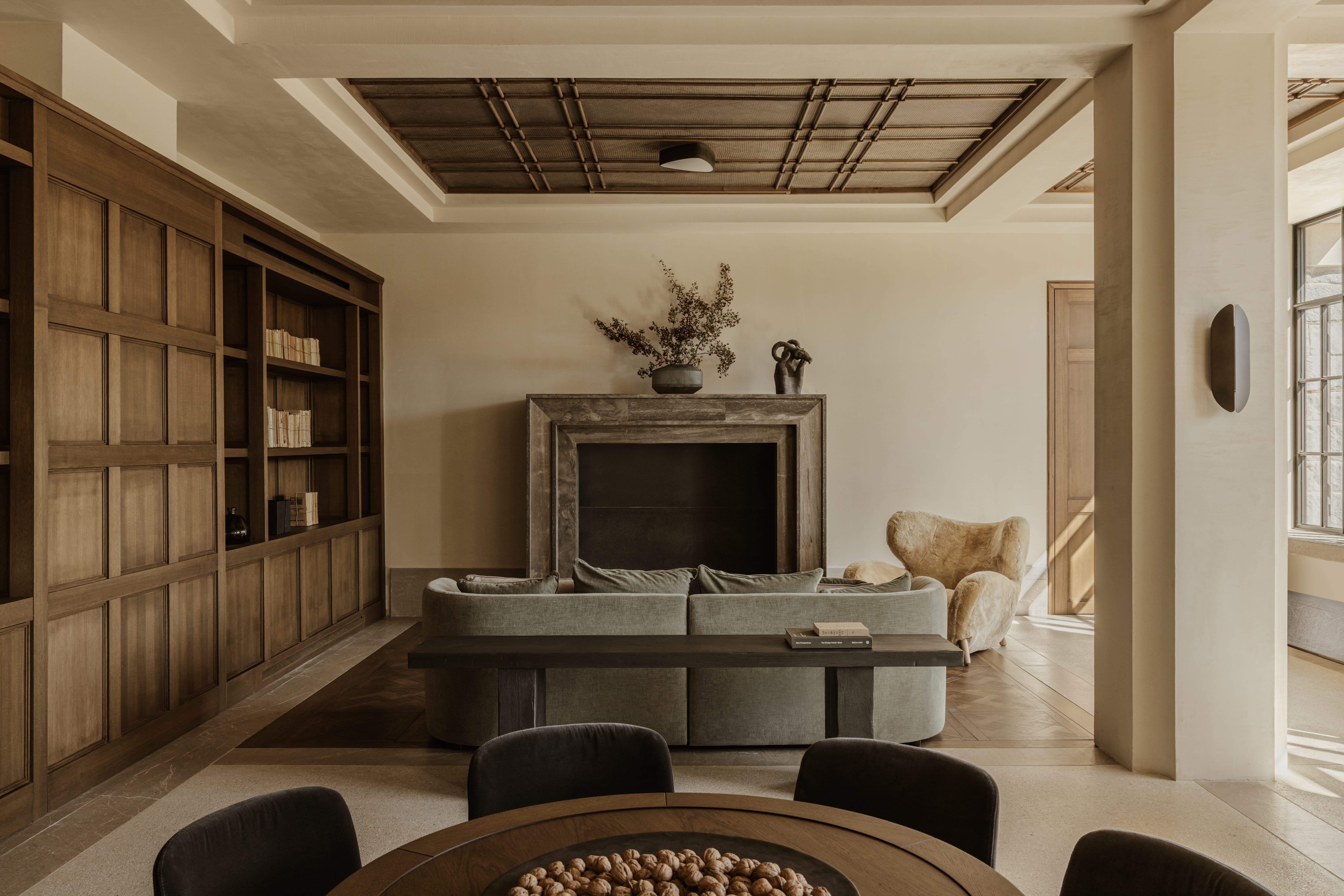 a living room with a tv and bookshelves