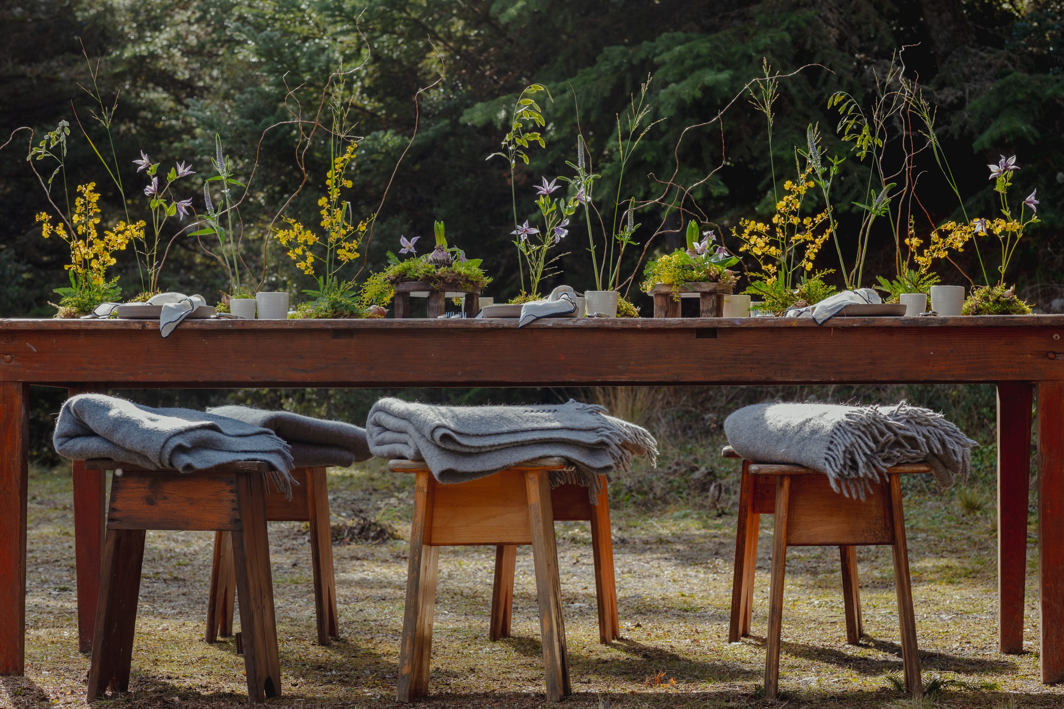 a table with chairs and a table with a blanket on it