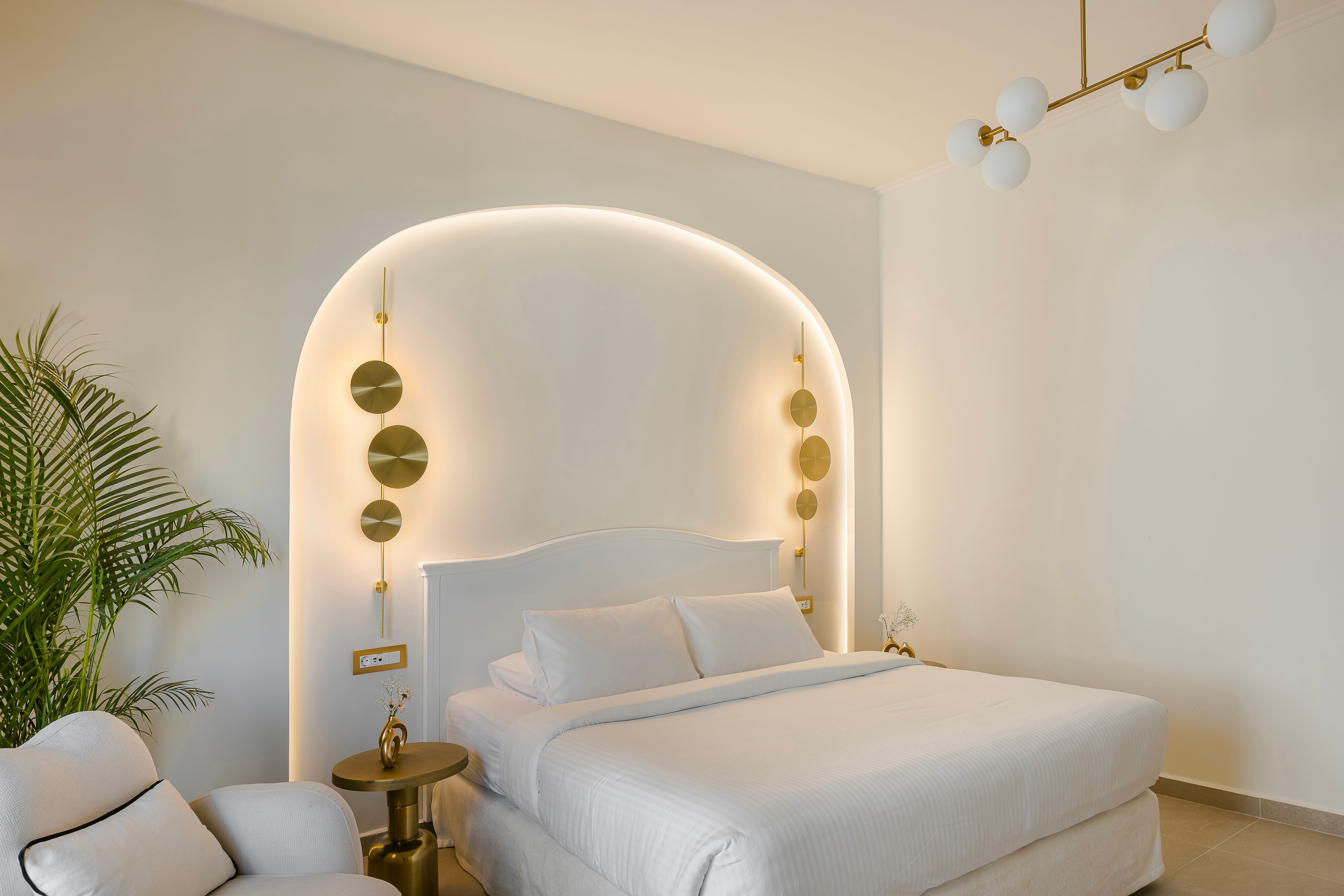 a room with a white couch and a white wall with lights