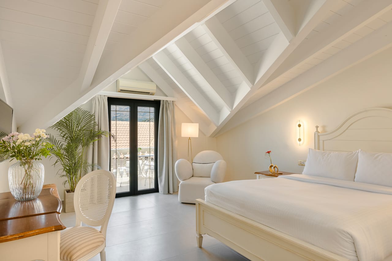 a bedroom with a bed and chairs