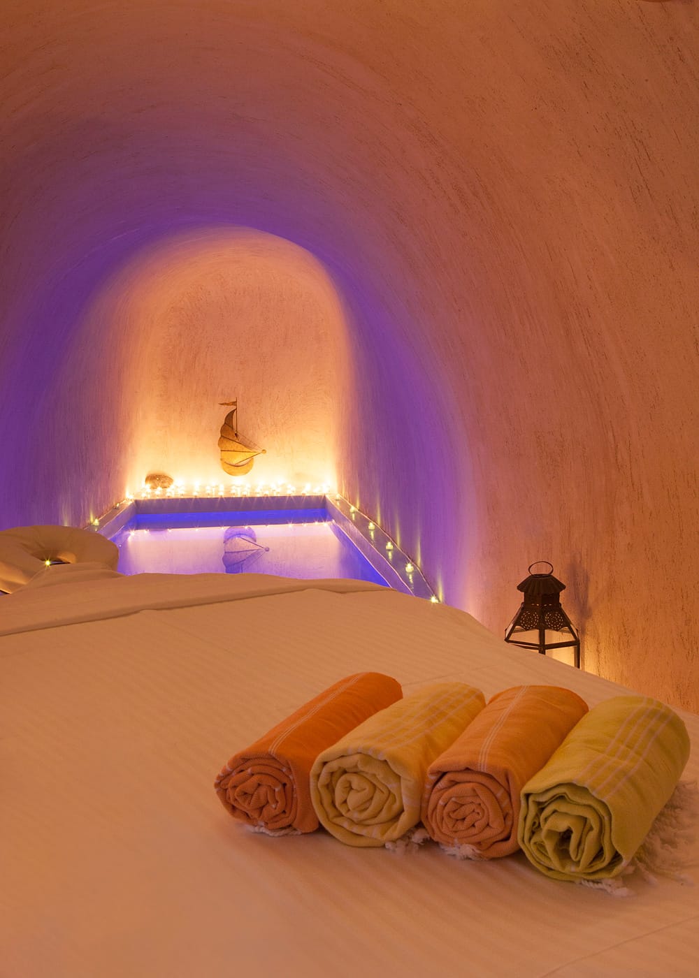 a bed with a pink wall