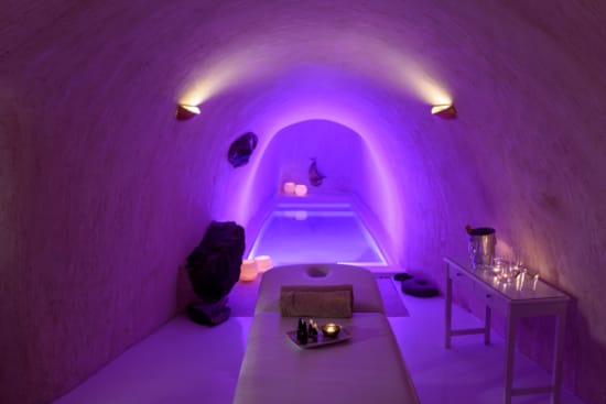 a room with a bed and a table with objects on it