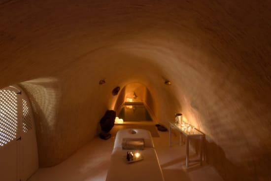 a room with a bed and a lamp