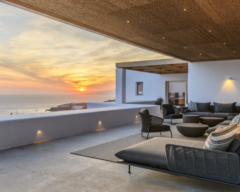 a room with a large pool and chairs