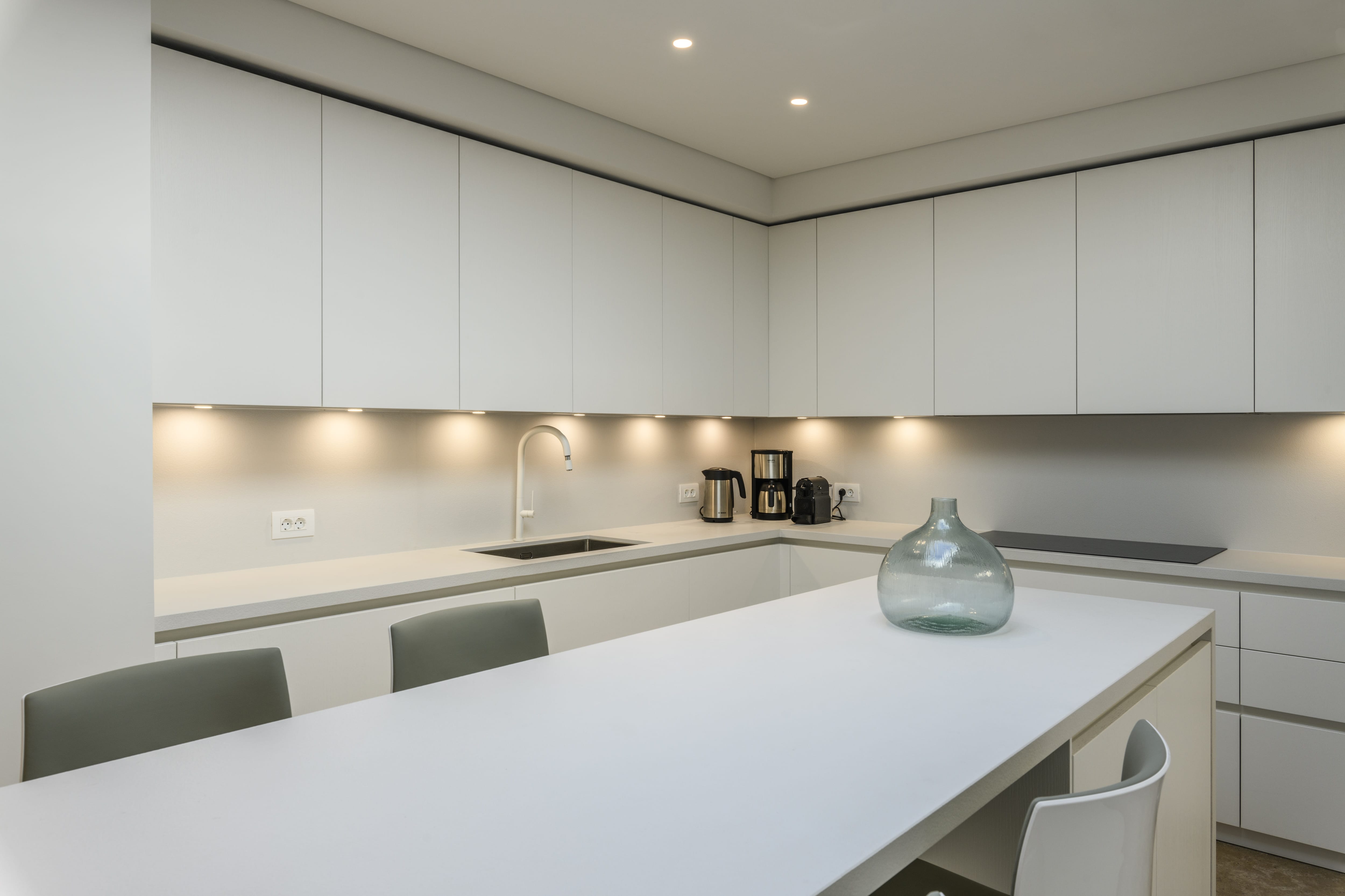 a kitchen with white cabinets