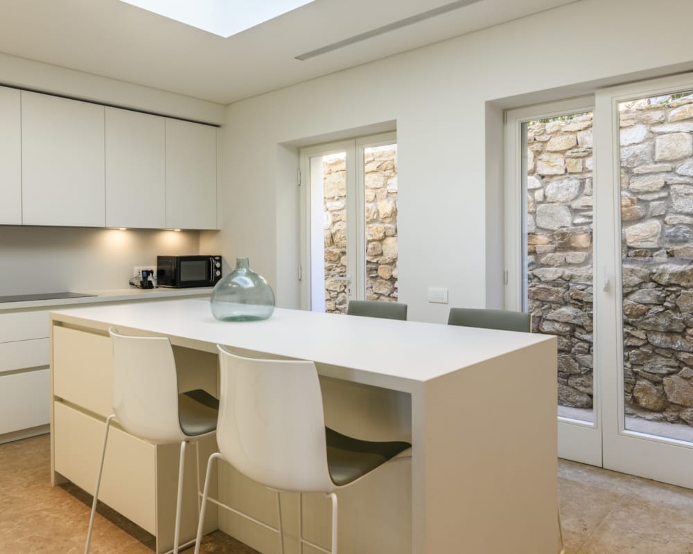 a kitchen with a table and chairs