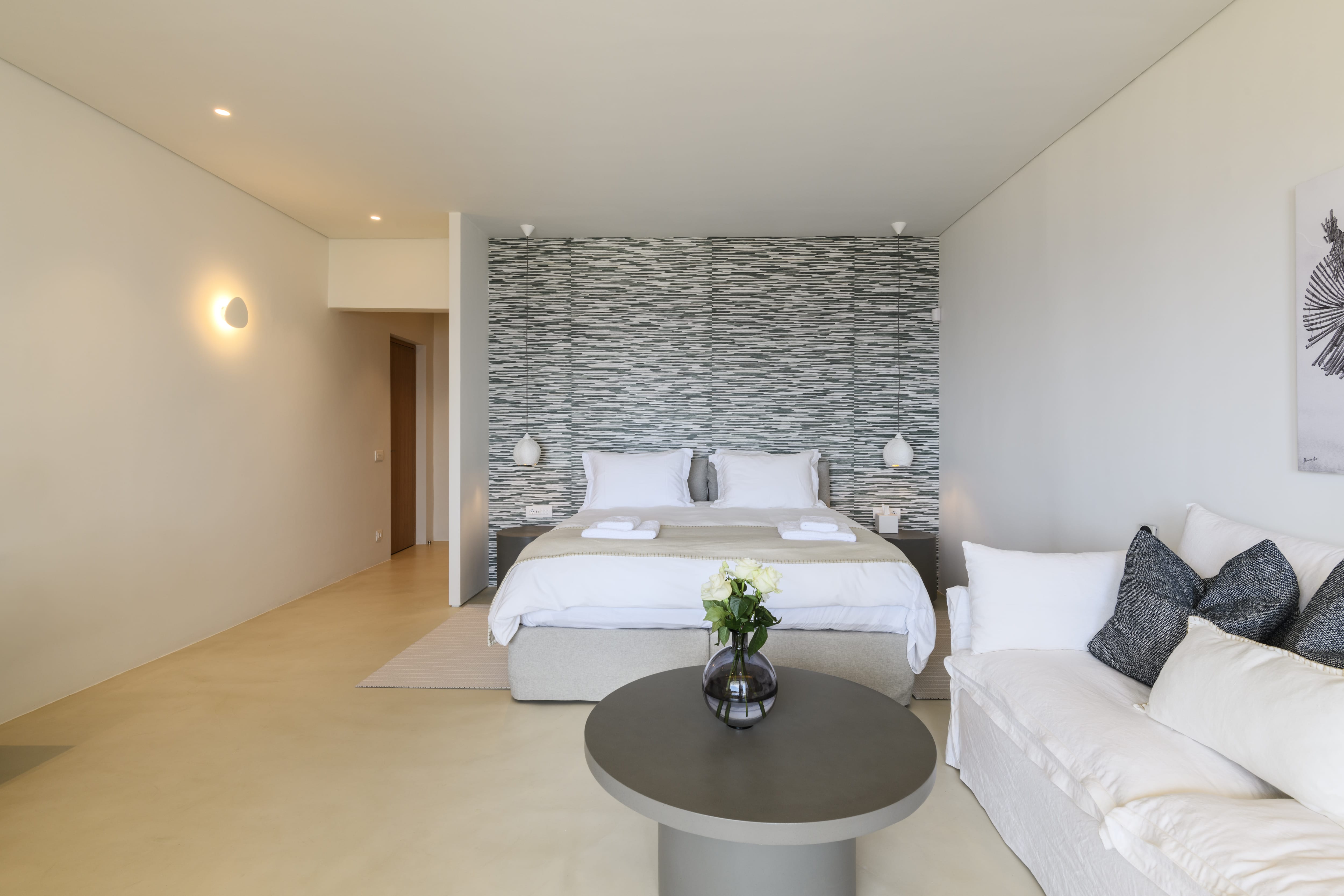 a room with a bed and couches