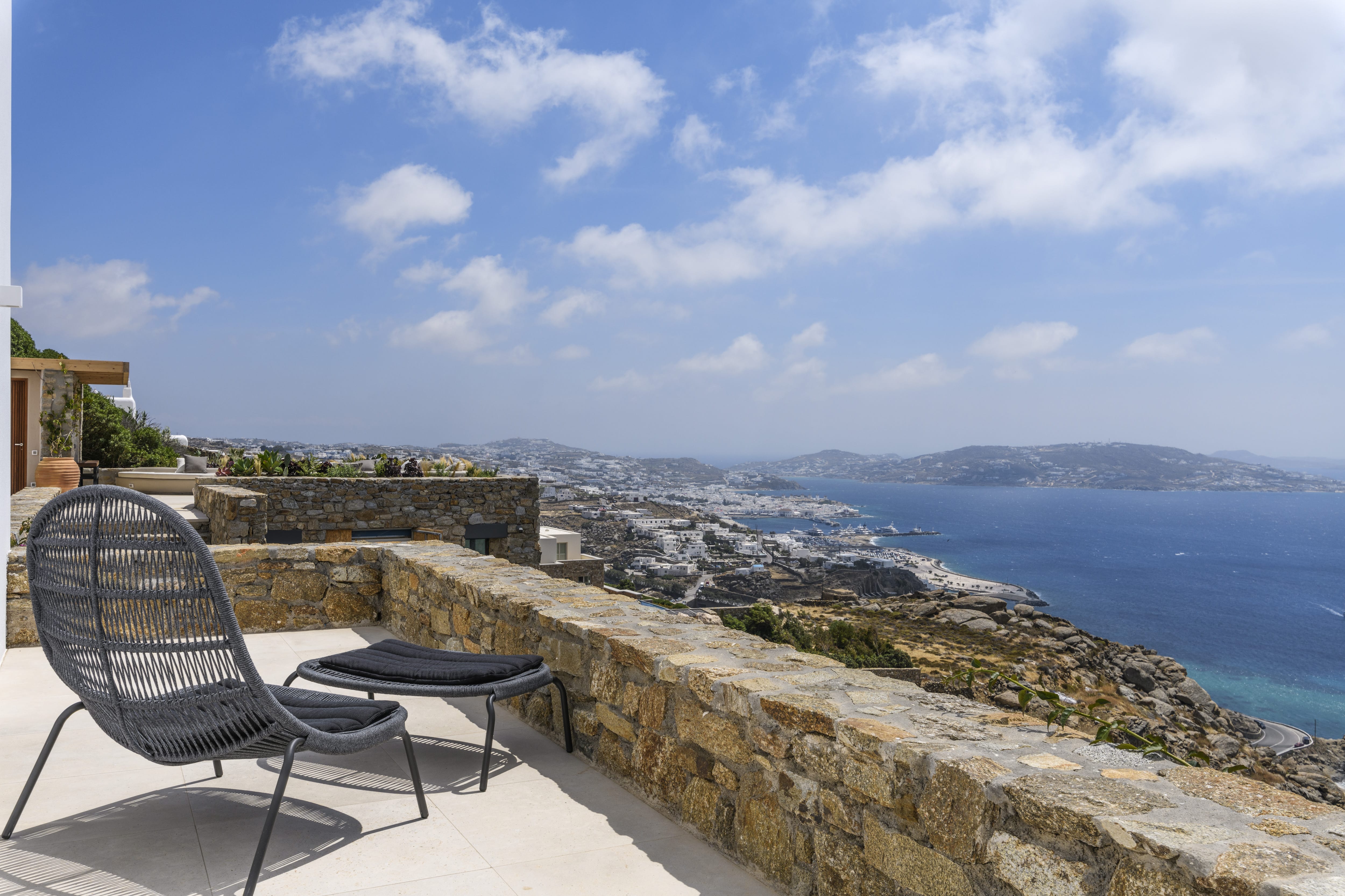 a chair on a ledge overlooking a city